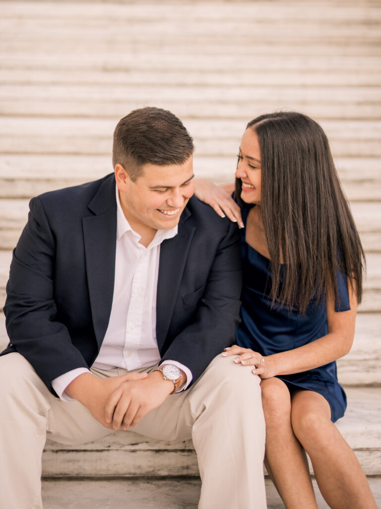 engaged couple sitting on steps at Detroit institute of arts