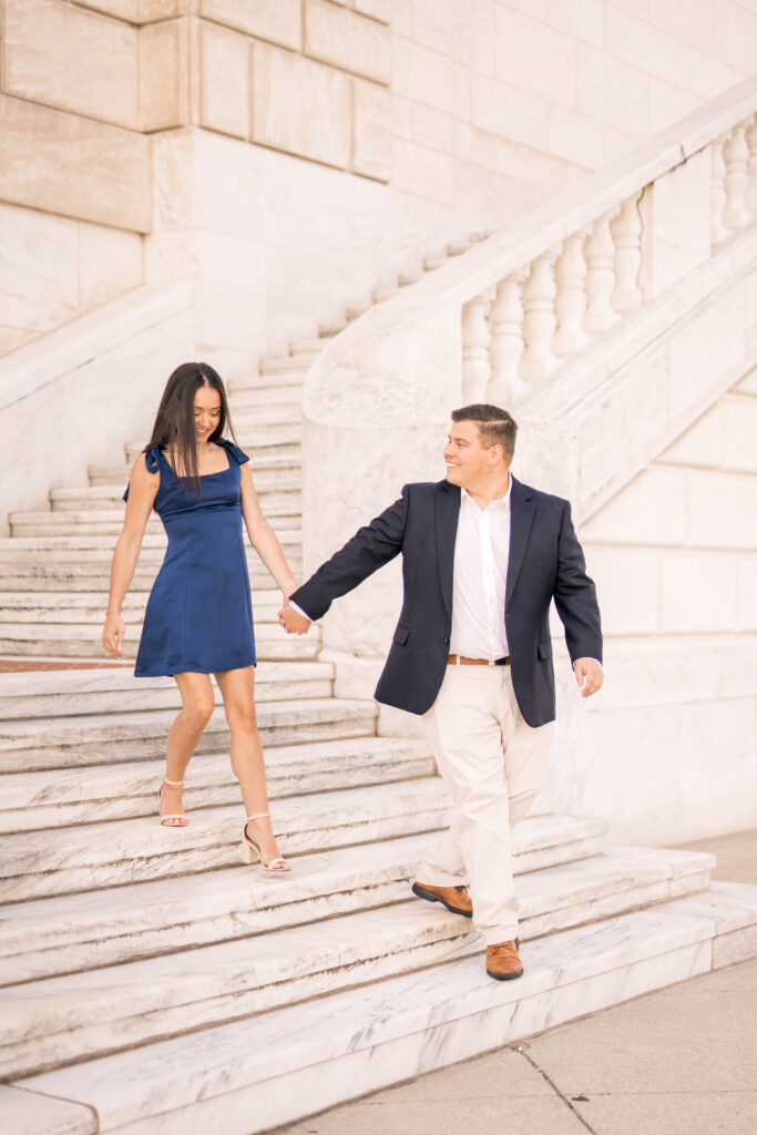 engaged couple walking on steps at Detroit institute of arts