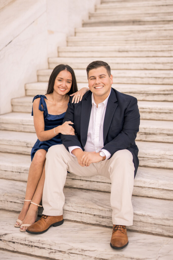 engaged couple sitting on steps at Detroit institute of arts