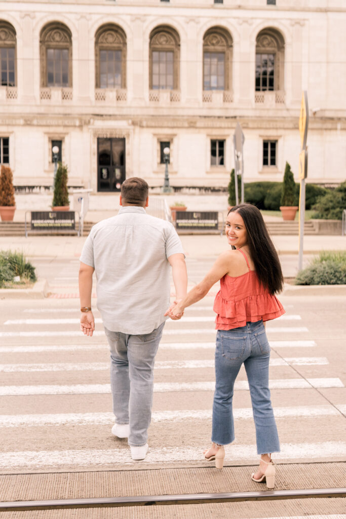 engaged couple at Detroit public library crossing street